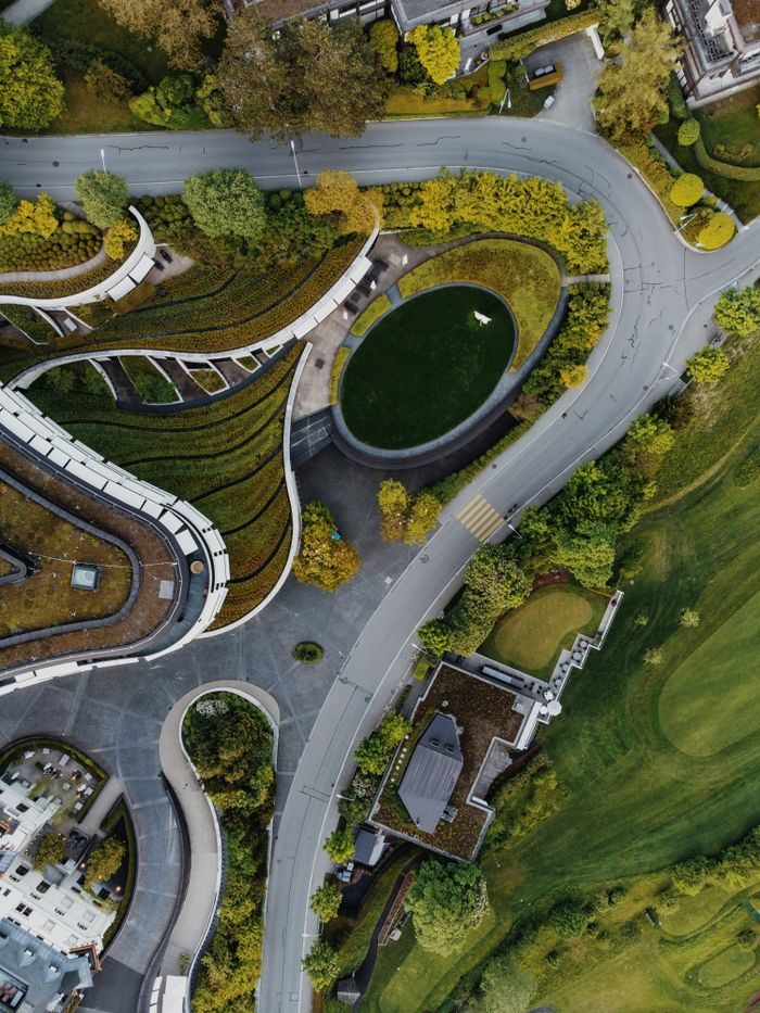 Stunning aerial shot showcasing green rooftops and winding roads.